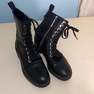 Black leather combat boots with silver hardware. Silver zipper on side
